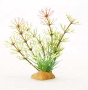 Artificial plant - a plant in the base with a small tuft of grass
